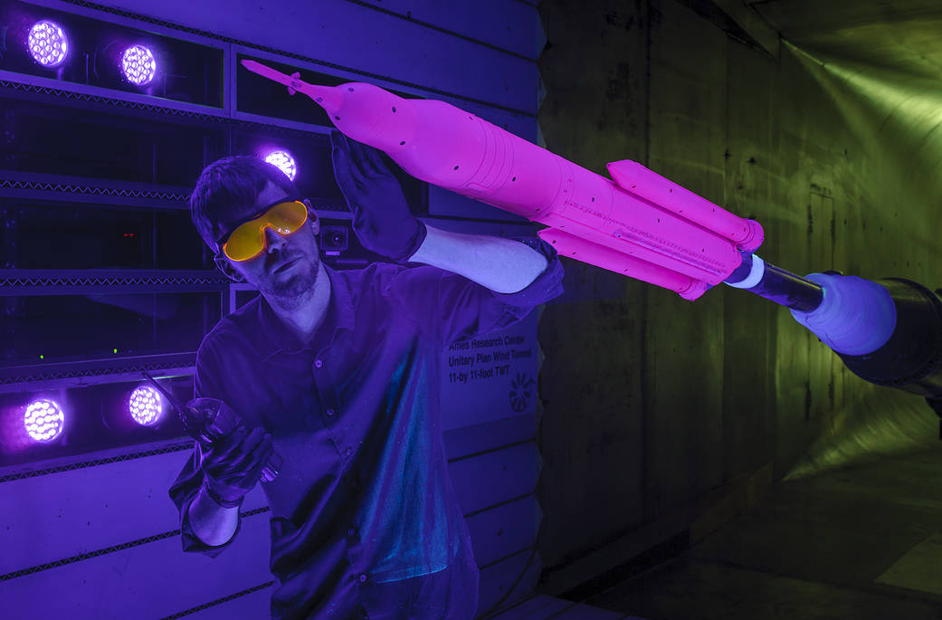 Dr. Patrick Shea inspects a nearly 4 3/4-foot (1.3 percent scale) model of SLS