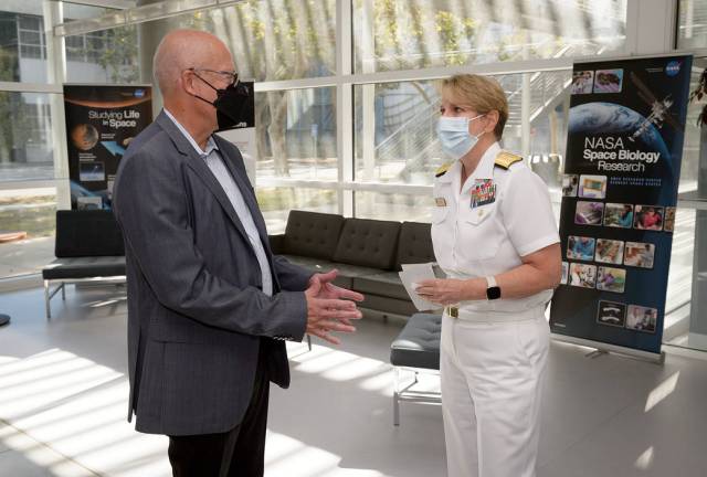 U.S. Navy Rear Admiral Anne M. Swap and Michael Hesse, director of science at NASA’s Ames Research Center in California’s Silicon Valley, talk in the lobby of the Biosciences Collaborative Facility at Ames.