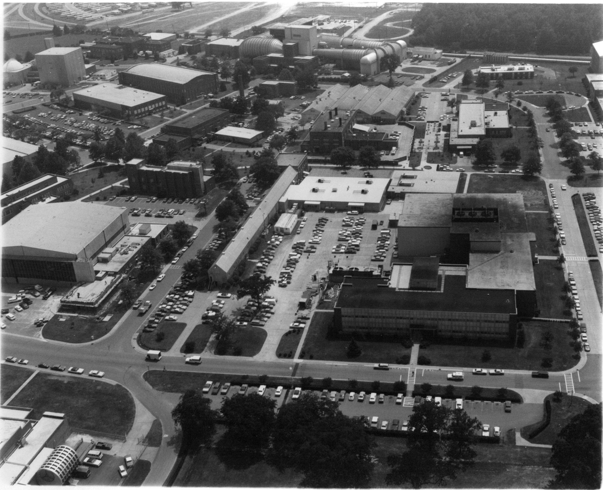 An aerial view, taken sometime between 1968 and 1978, of the Impact Basin, West Model Shop and 16-Foot Tunnel. The long, narrow building in the middle of the photograph is the Impact Basin.