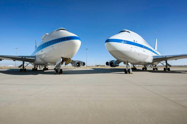 SOFIA) and the Pratt and Whitney Canada 747SP testbed sit nose-to-nose at NASA Armstrong Flight Research Center’s Building 703 i