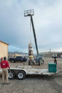 Masten Space Systems’ technician making adjustments to NASA’s autonomous landing technologies payload on Masten’s Xodiac rocket.