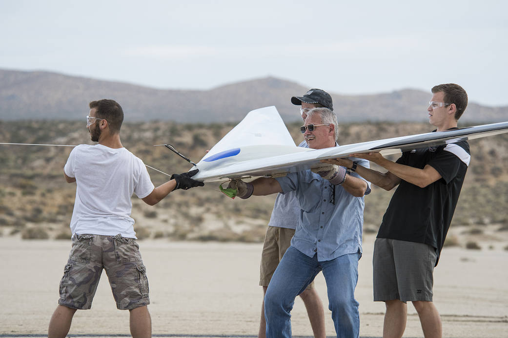 Al Bowers, center, and a group of student interns hook up a bungee cord for a flight of the Prandtl-D 3C glider.