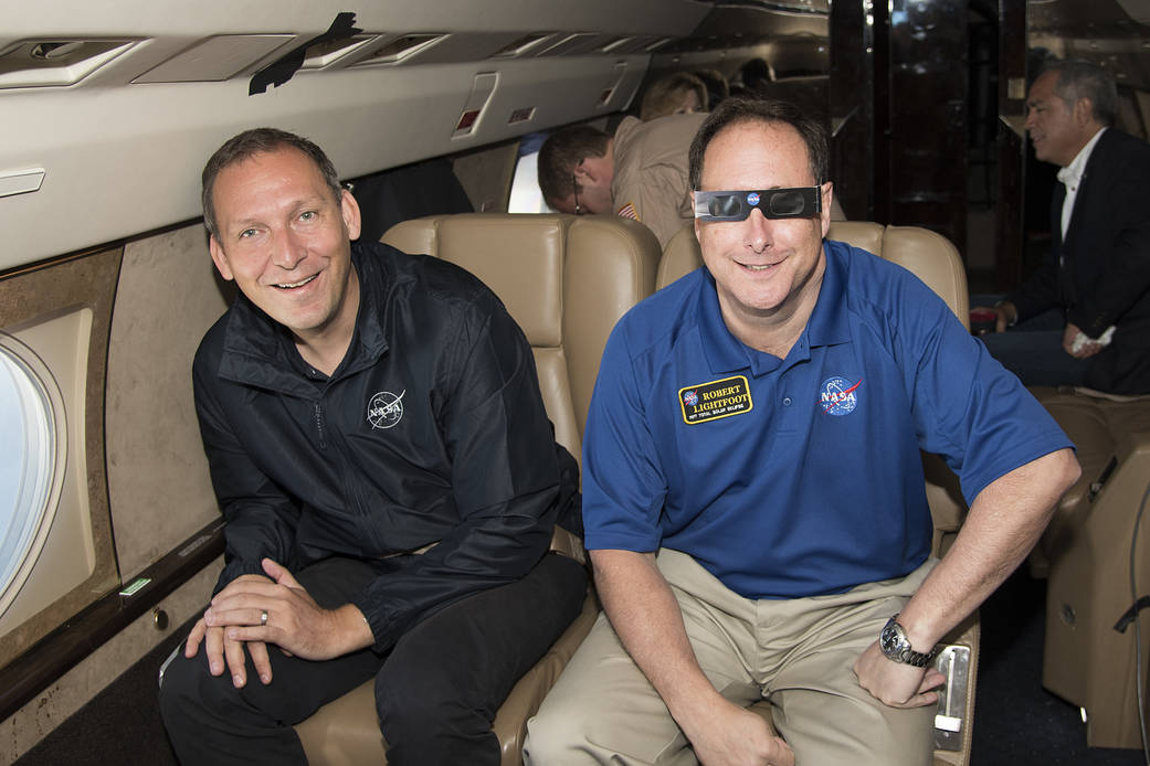 Thomas Zurbuchen and Robert Lightfoot waiting for the partial eclipse to occur aboard Armstrong Flight Research Center's G-III.