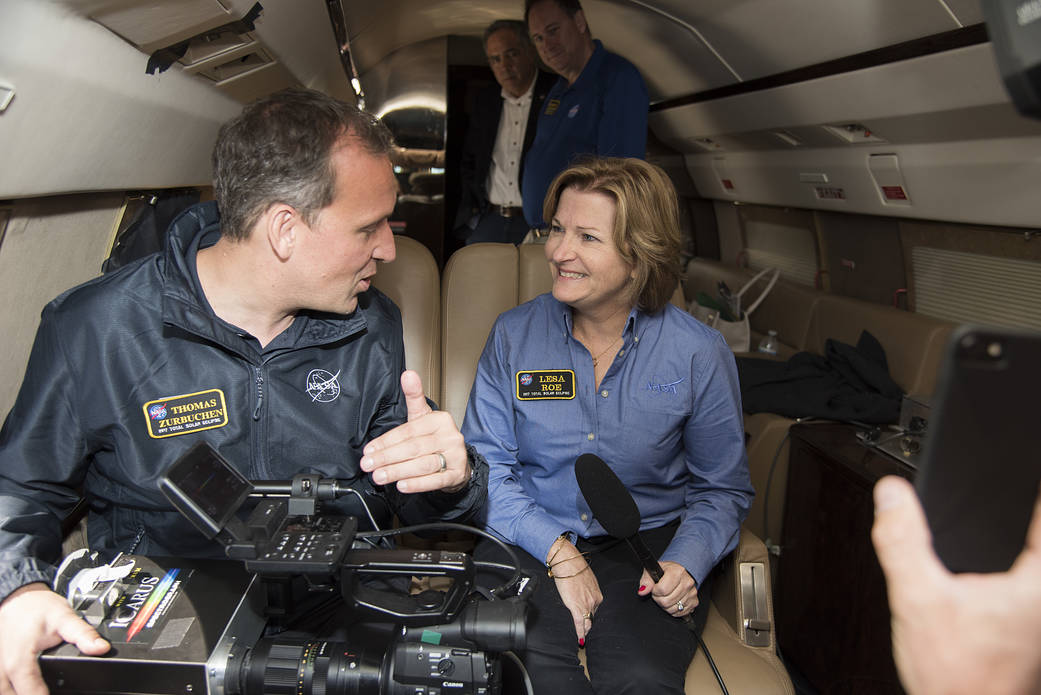 Thomas Zurbuchenexplains how the spectrograph works to Lesa Roe.