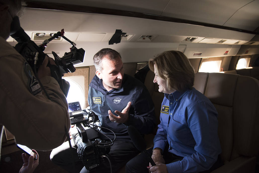 Thomas Zurbuchenexplains how the spectrograph works to Lesa Roe.