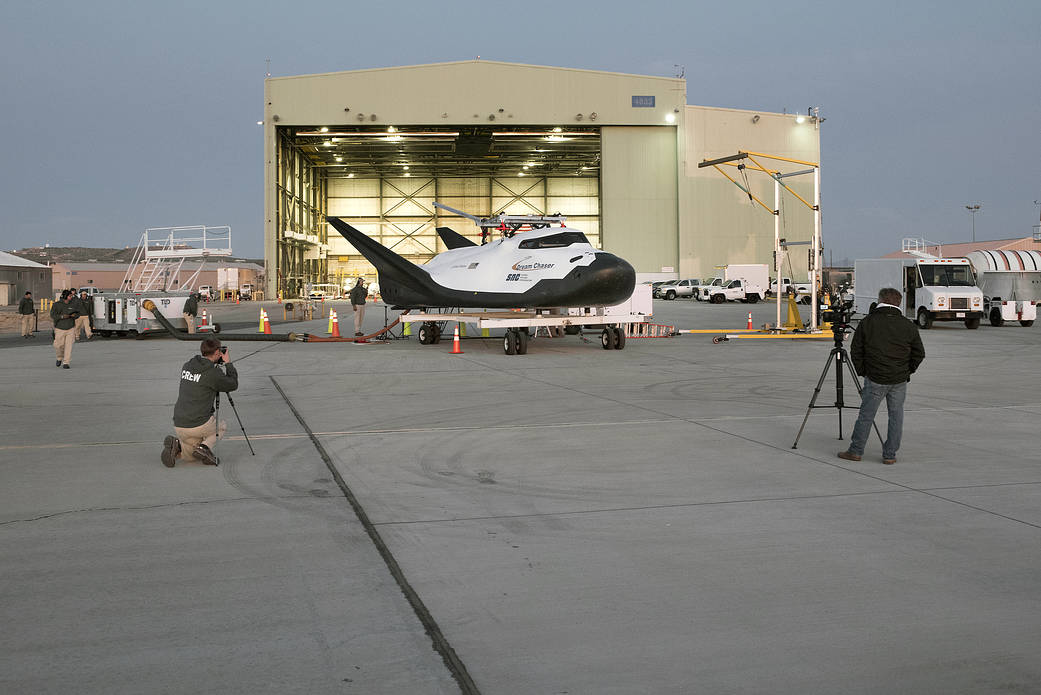 Sierra Nevada Corp’s Dream Chaser being towed from the former space shuttle hangar at AFRC.