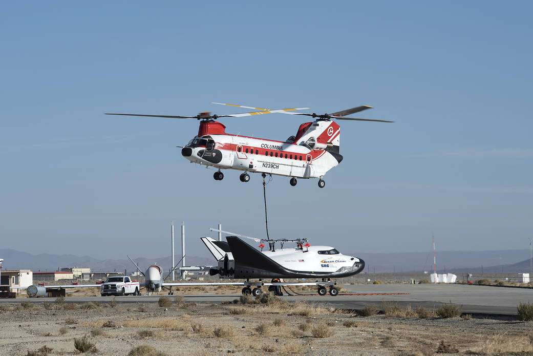 Sierra Nevada Corp’s Dream Chaser being lifted by helicopter from the ramp at NASA’s Armstrong Flight Research Center 