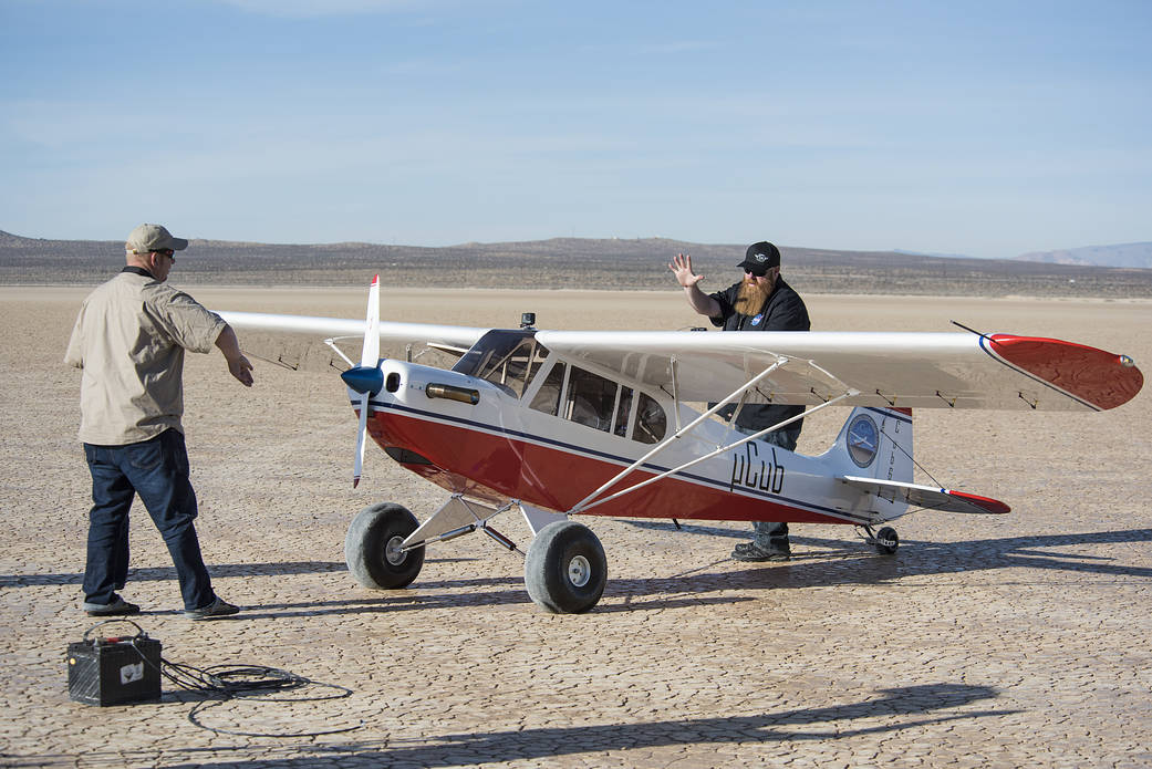 Crew members perform a series of preflight system checks on the MicroCub.