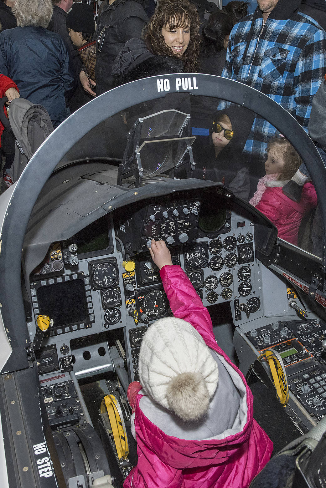A young woman tries her hand at “piloting” a high-performance jet.