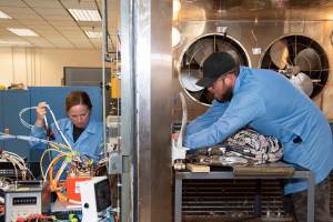 April Torres and Kyle Dauk set up for a thermal test of components in the Environmental Laboratory at NASA’s AFRC.