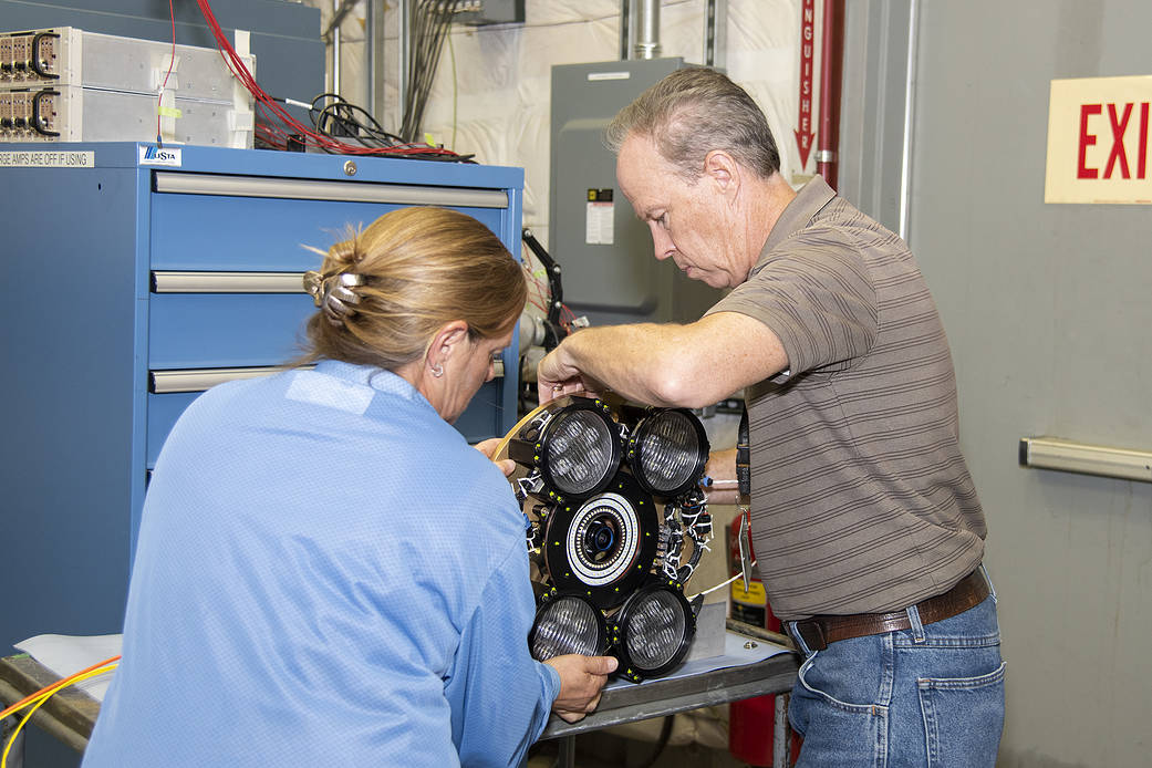 AFRC technicians prepare a camera system for vibration testing at AFRC.