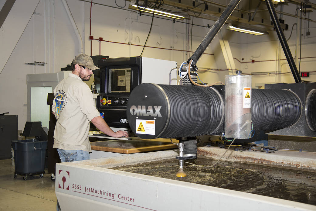 Eric Nisbet works on a part for the ER-2 instrument panel.