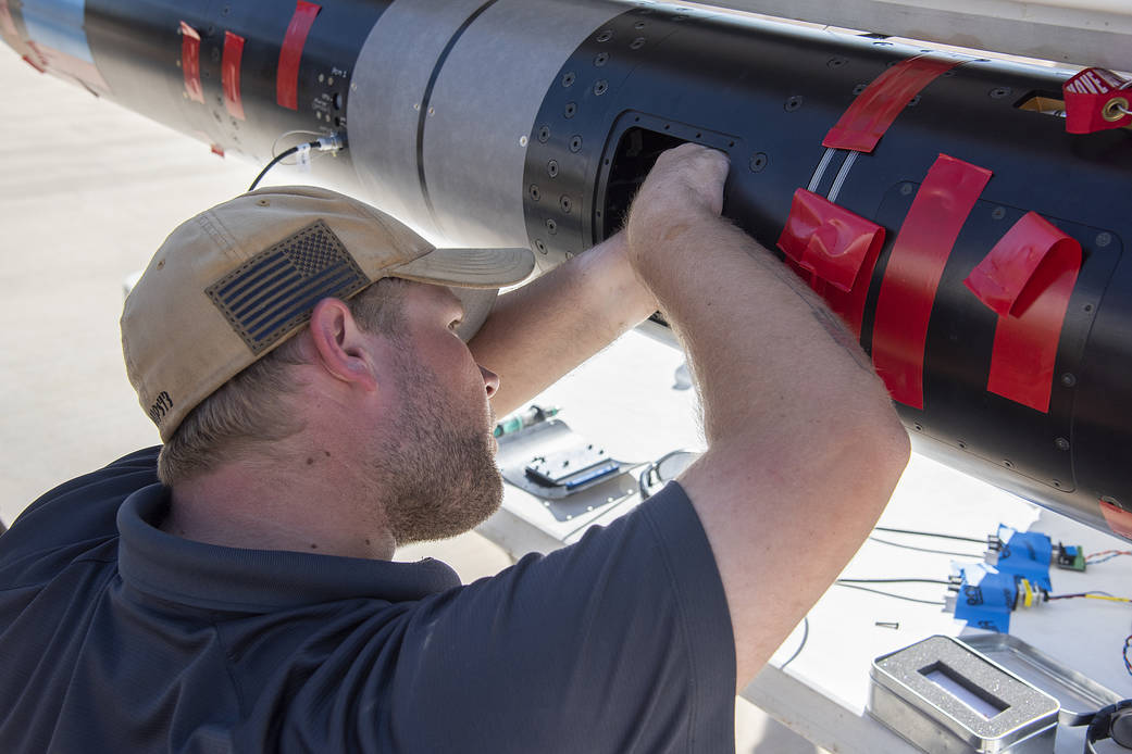 An UP Aerospace employee prepares their SpaceLoft rocket for a flight that will carry NASA technologies.