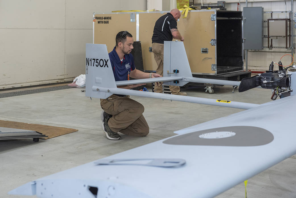 Daryl Ferguson attaches the TigerShark’s tail at NASA’s Armstrong Flight Research Center in California.