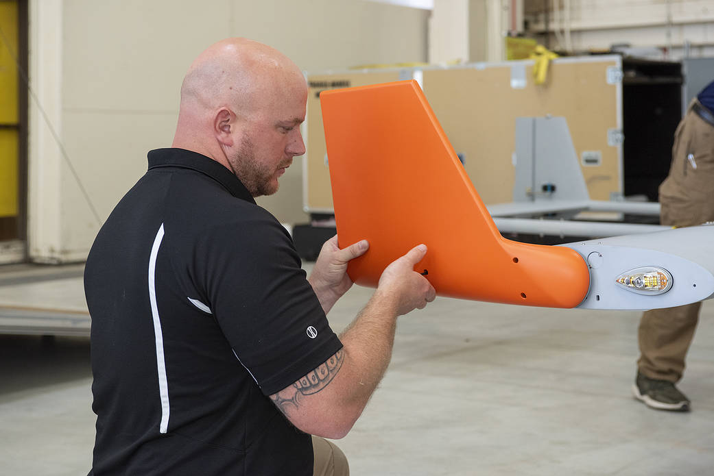 Brad Petty from Navmar Applied Sciences Corporation attaches a winglet to the TigerShark upon arrival at NASA AFRC.