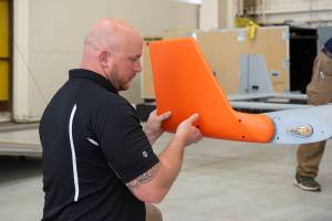 Brad Petty from Navmar Applied Sciences Corporation attaches a winglet to the TigerShark upon arrival at NASA AFRC.