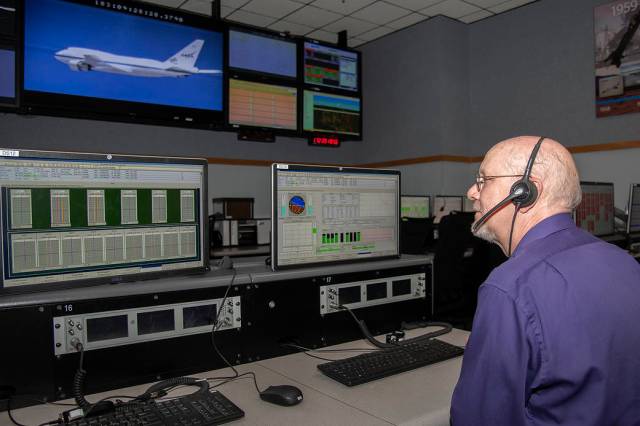 Kevin Knutson sits at a station in the main Blue Control Room at NASA’s Armstrong Flight Research Center in California.