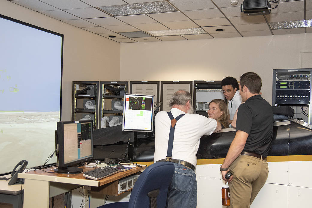 NASA's 2017 astronaut candidates practice flying in an F-18 aircraft cockpit simulator at AFRC.