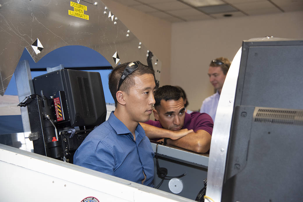 NASA’s 2017 astronaut candidates practice flying in an X-59 QueSST simulator at AFRC.