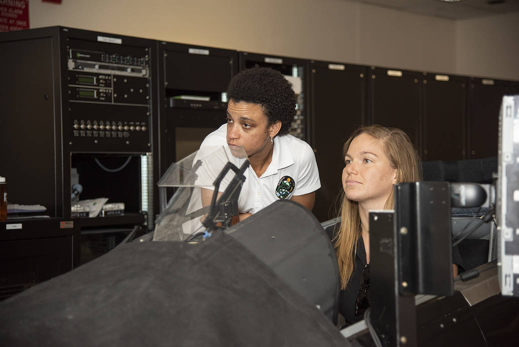 NASA's 2017 astronaut candidates practice flying in an F-18 aircraft cockpit simulator at AFRC.
