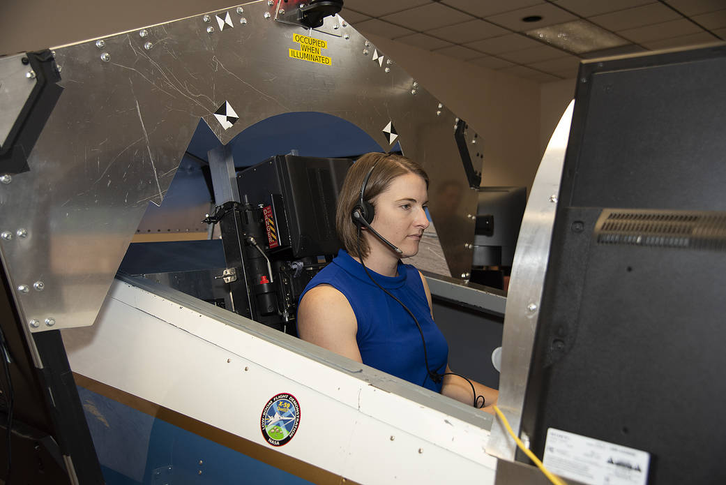 NASA's 2017 astronaut candidate Kayla Barron practices flying in an X-59 QueSST simulator at AFRC.