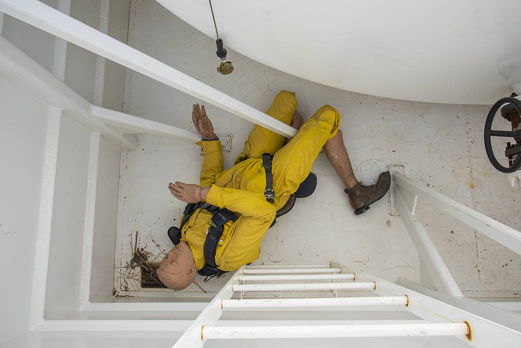 A mannequin is used to simulate a worker who has collapsed and come free from a harness during a confined space exerciese.
