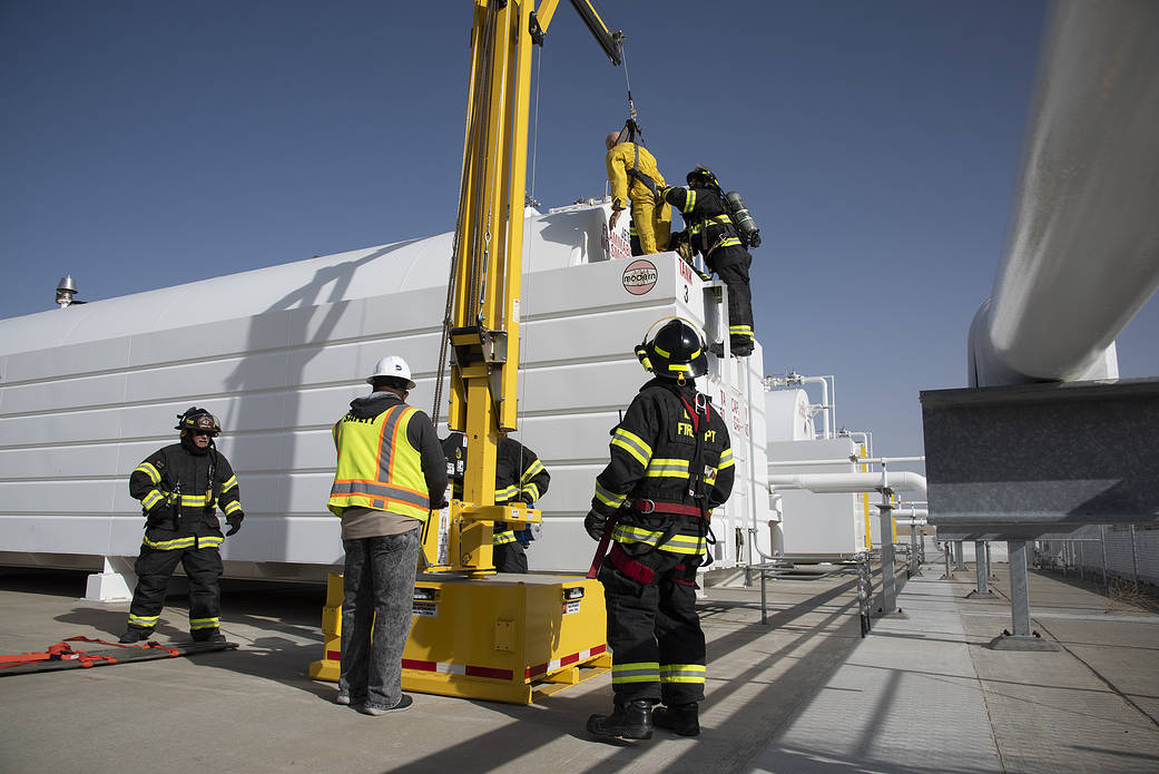Syd Myers observes U.S. Air Force Plant 42 Fire Department responders extract a mannequin from a confined space.