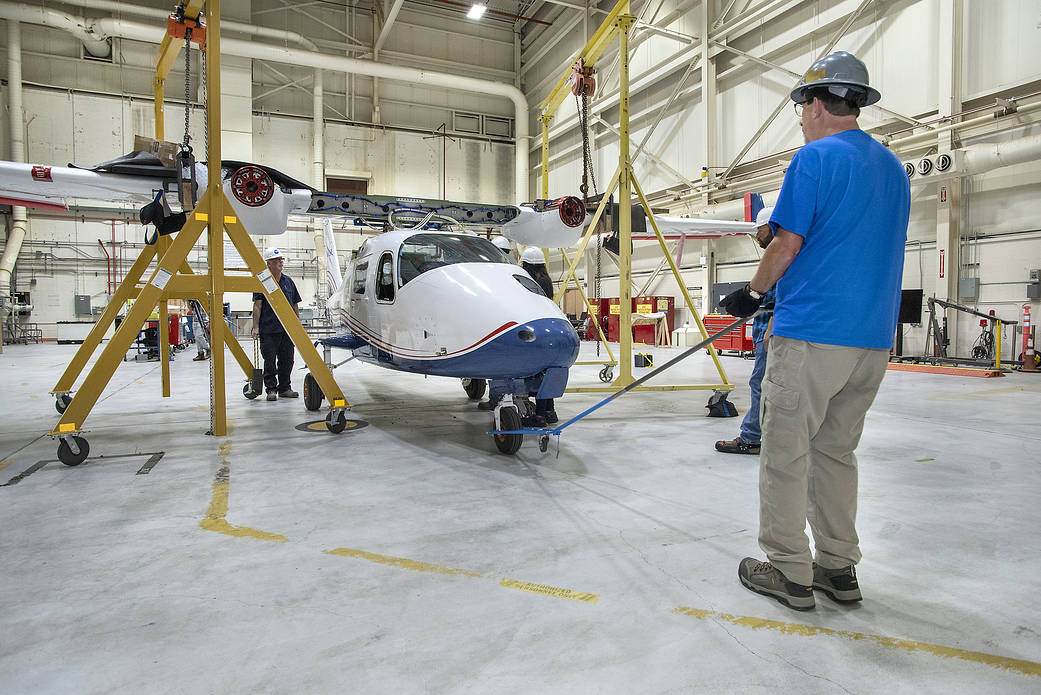 The X-57 fuselage is positioned under the Mod II wing section so that it can be reattached.