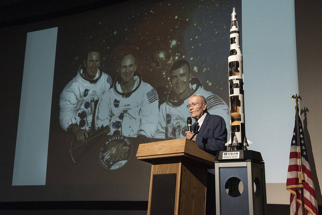 Apollo Astronaut Fred Haise speaks to a crowd of NASA and U.S Air Force employees at the Edwards Air Force Base theater.