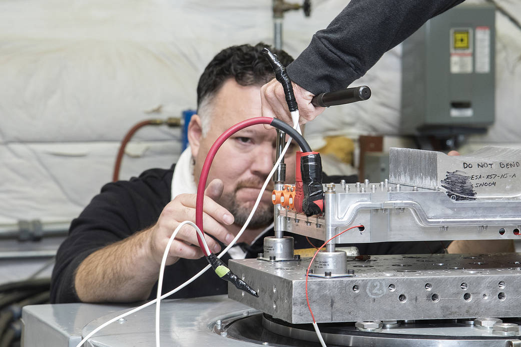 Engineers from NASA’s Armstrong Flight Research Center and Empirical Systems Aerospace prepare a cruise motor controller.