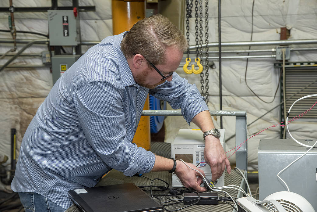 Engineers from NASA’s Armstrong Flight Research Center and Empirical Systems Aerospace prepare a cruise motor controller.