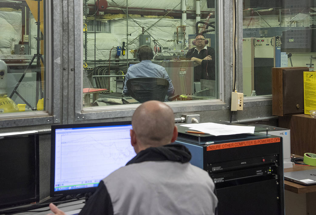 Engineers monitor data during vibration testing of a cruise motor controller for the X-57 Maxwell.