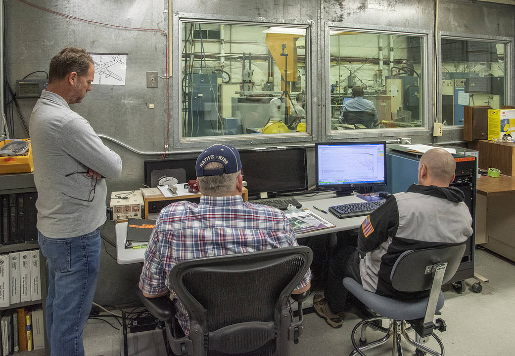 Engineers monitor data during vibration testing of a cruise motor controller for the X-57 Maxwell.