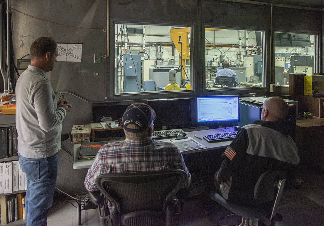 Engineers monitor data during vibration testing of a cruise motor controller for the X-57 Maxwell.