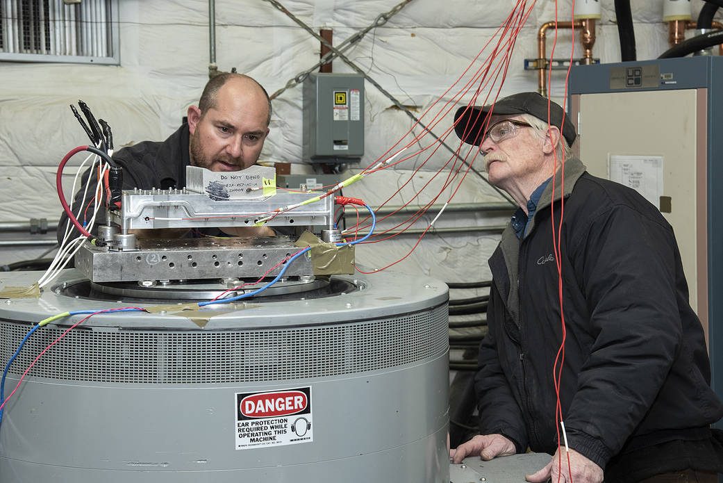 Engineers prepare a cruise motor controller, planned to be used on NASA’s all-electric X-57 Maxwell.