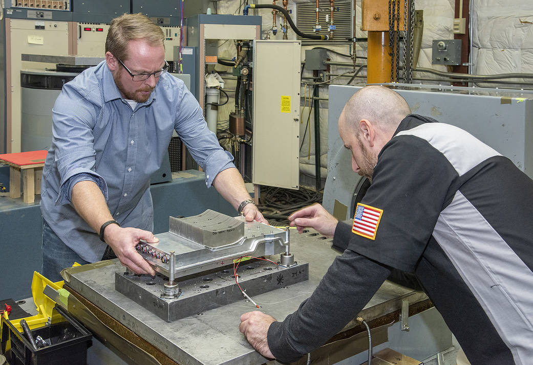 Engineers prepare a cruise motor controller for the X-57.