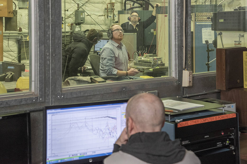 Engineers monitor data during vibration testing of a cruise motor controller for the X-57 Maxwell.