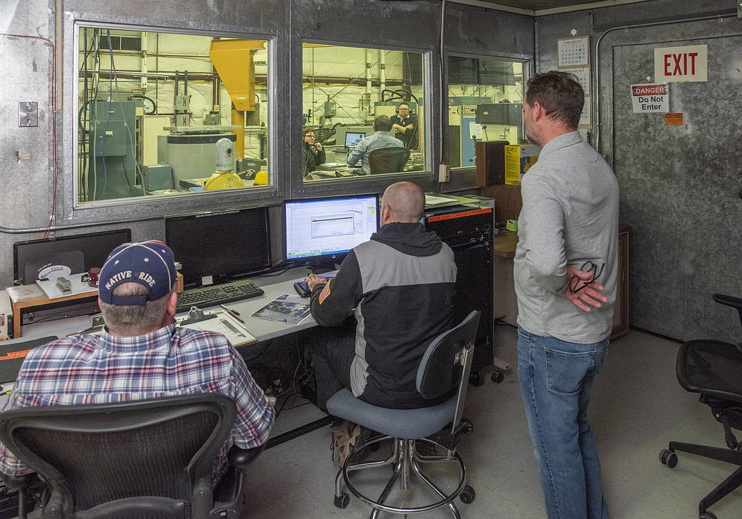 Engineers monitor data during vibration testing of a cruise motor controller for the X-57 Maxwell.