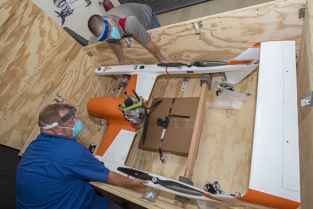 Derek Abramson and Robert Jensen assemble pieces of the Hybrid Quadrotor 90C (HQ-90).