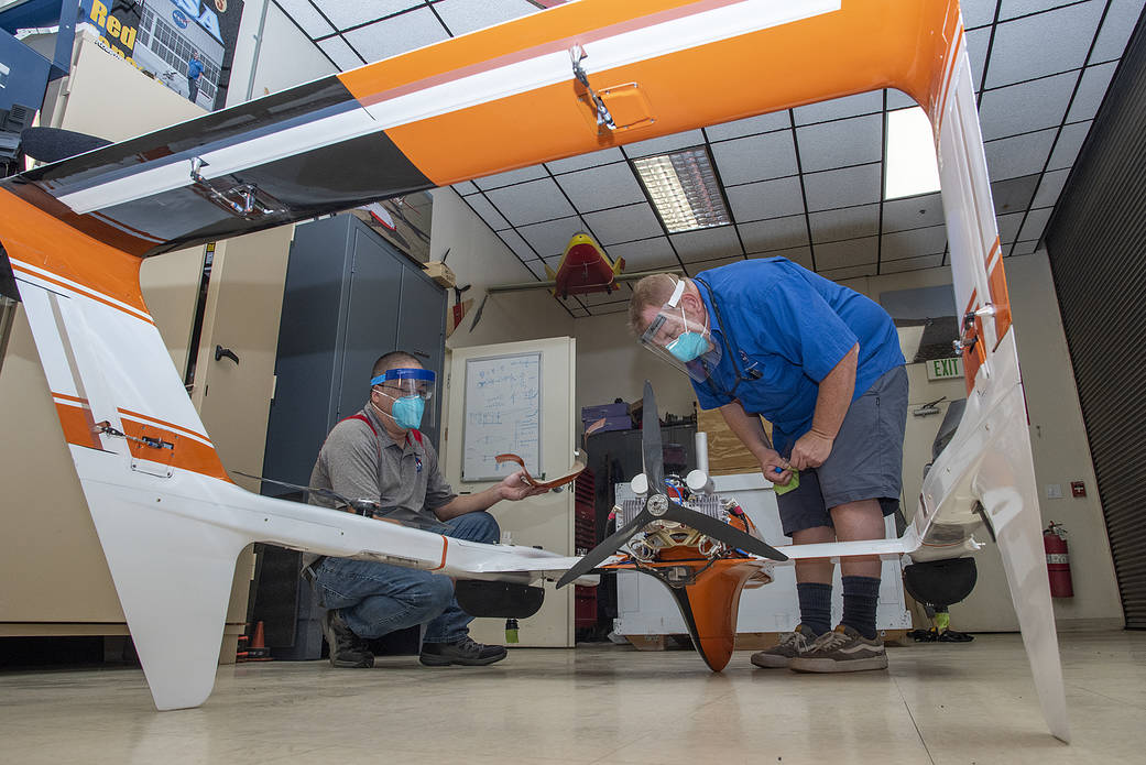 Derek Abramson and Robert Jensen assemble pieces of the HQ-90.
