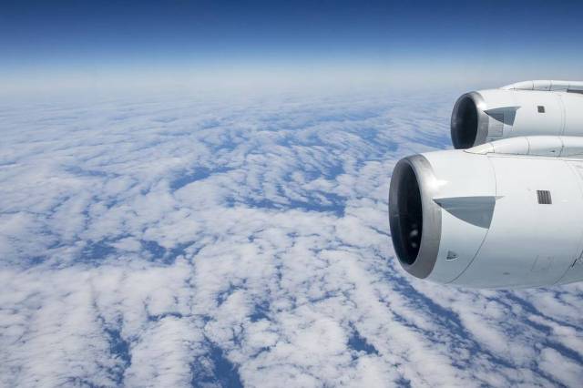 Airplane engines captured while in flight over clouds.