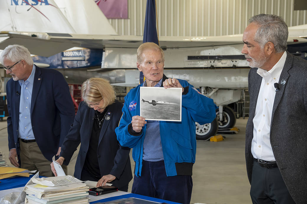 NASA Administrator Bill Nelson shows a picture of the X-3 to NASA Armstrong Flight Research Center Director David McBride