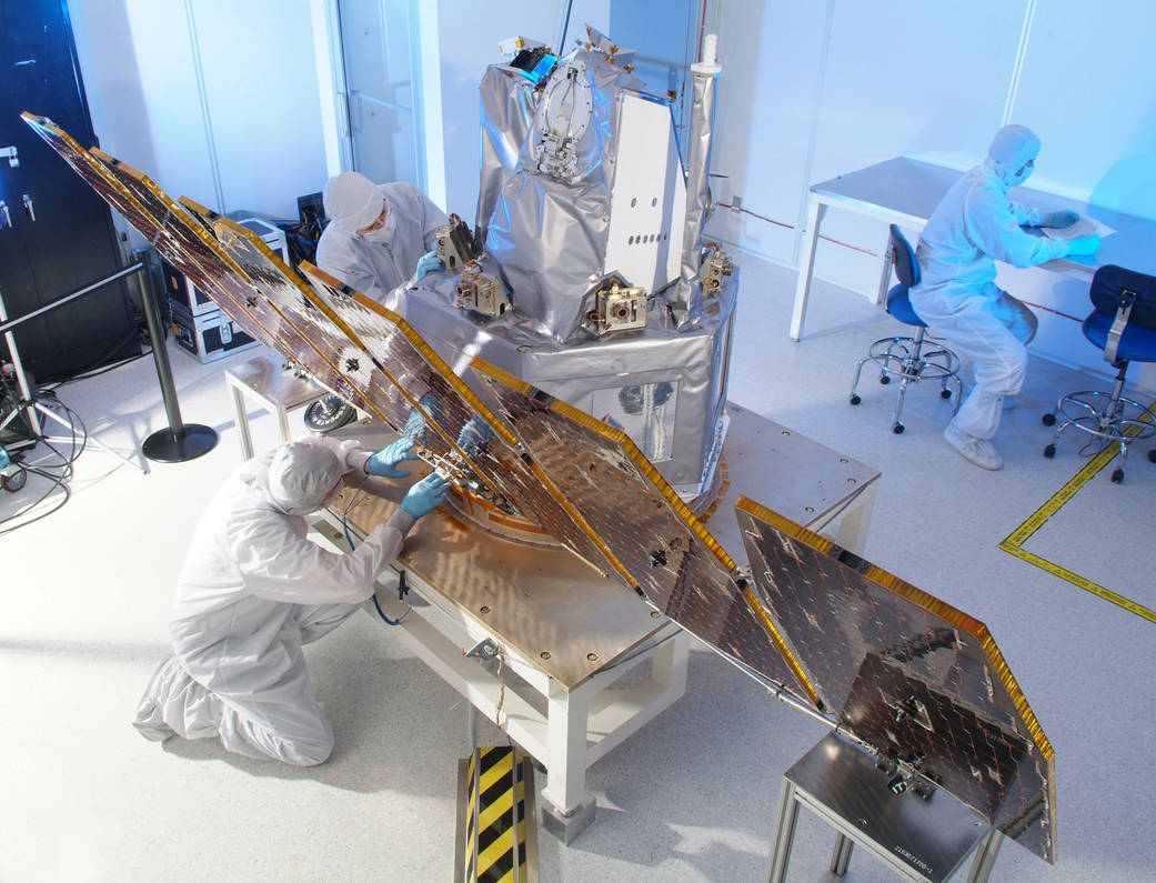 The AIM spacecraft undergoes solar array deployment tests and is shown here in full deployment.