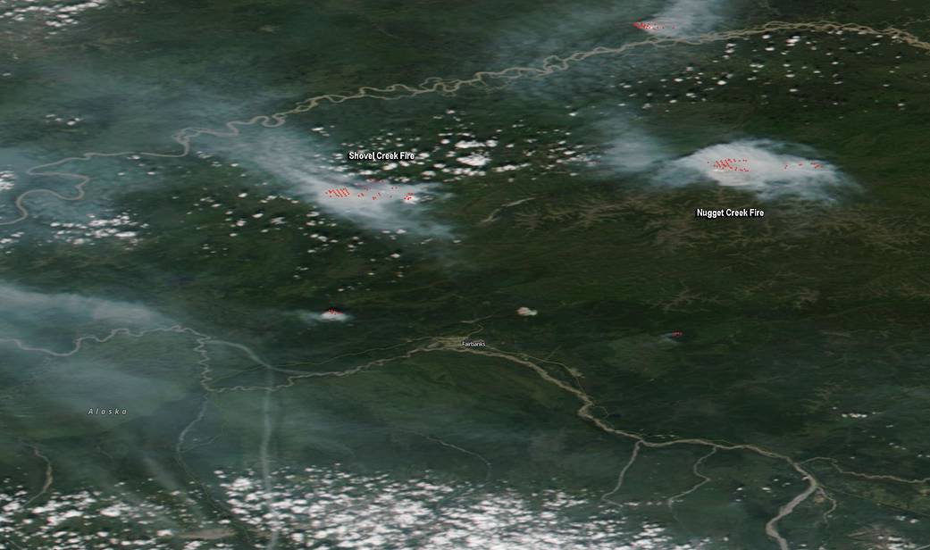 green satellite image with wisps of smoke