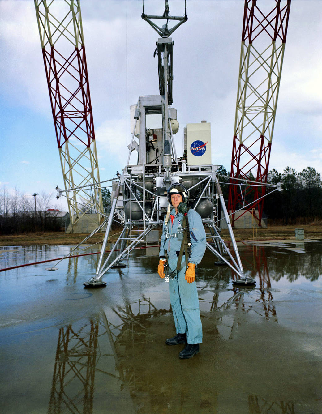 Neil Armstrong in flight suit with lunar module simulator