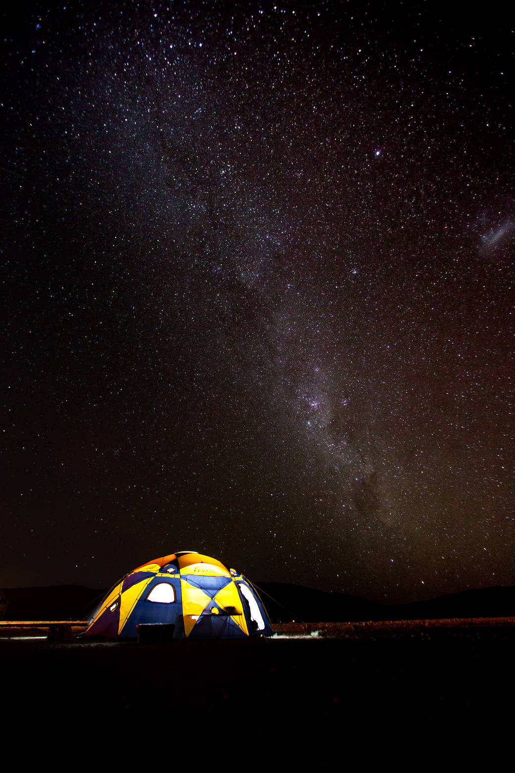 The Milky Way is seen in the sky behind a tent in the Atacama Desert in northern Chile.