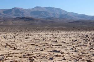 The features in the foreground, taken six months after a rain event, resemble a muddy puddle that has dried up.