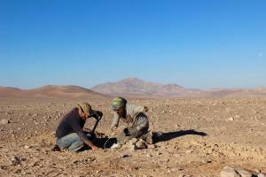 Two members of the ARADS science team dig up the sensors they had buried in the Atacama Desert one year earlier.