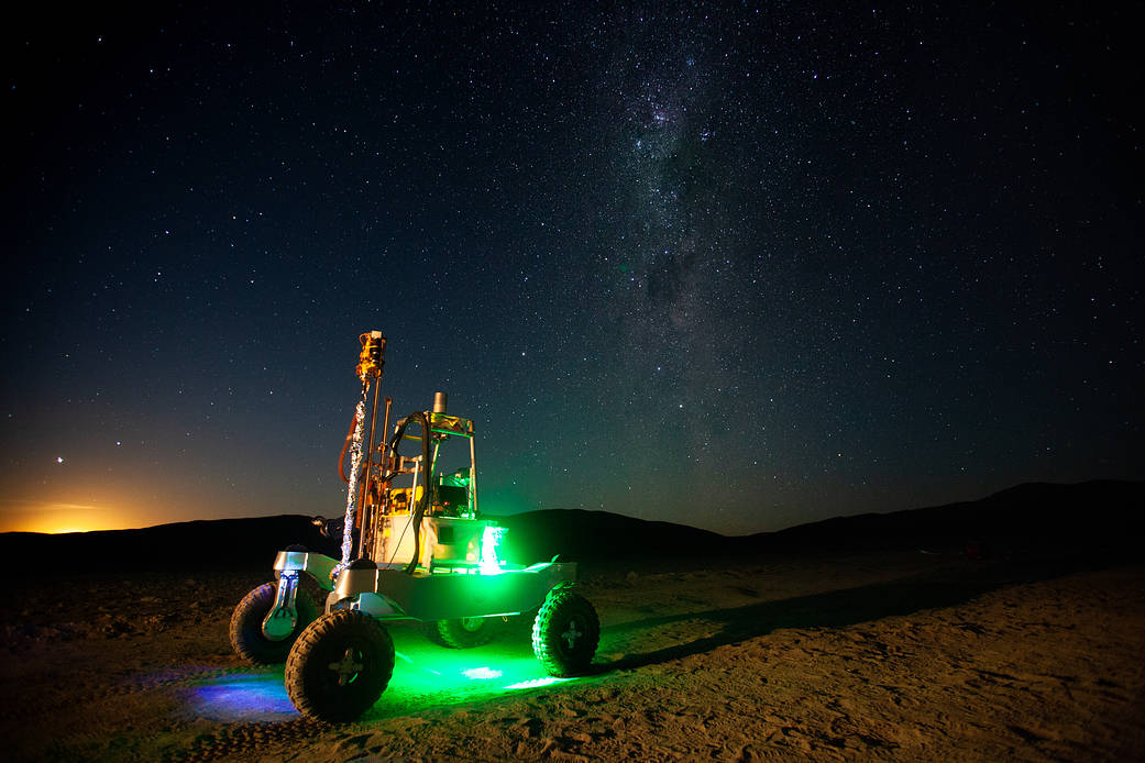 The Moon begins to rise behind the ARADS rover in Chile’s Atacama Desert. The Milky Way is visible in the night sky.