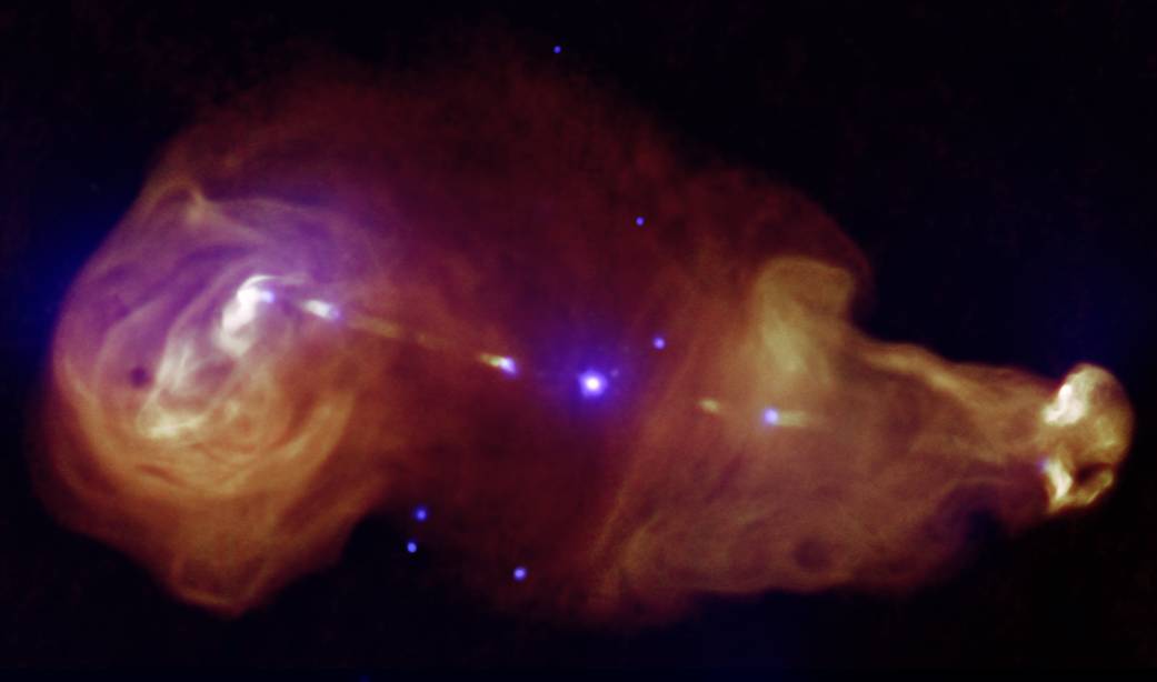 3C353 is a wide, double-lobed source where the galaxy is the tiny point in the center and giant plumes of radiation can be seen.